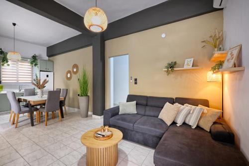 a living room with a couch and a table at El Dorado Corner with Hot Tub in Chania