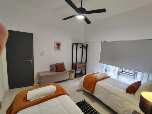a living room with a couch and a ceiling fan at CM Descanso boutique in Colorado River