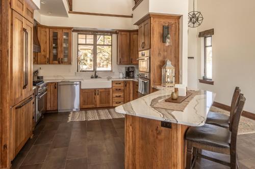 a kitchen with wooden cabinets and a large island at Creekside Chalet in Big Sky