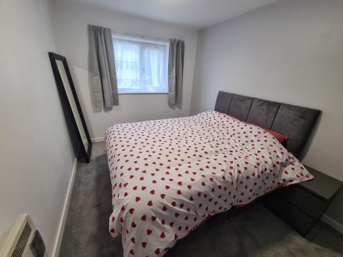 a bedroom with a bed with a polka dot bedspread at Mailbox and Broad St in Birmingham