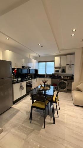 a kitchen with a table and chairs in a room at Appartemet city centre kenitra in Kenitra
