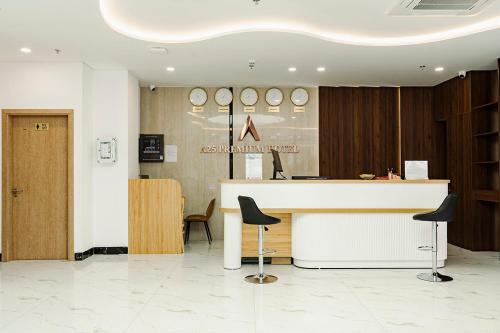 a lobby with a counter and chairs in a room at A25 Premium Hotel - 36 Giang Văn Minh in Hanoi