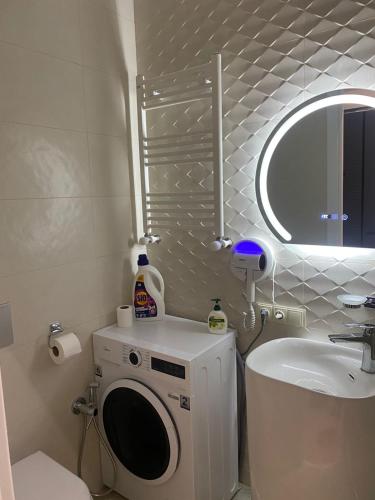 a bathroom with a washing machine and a sink at Home in Kutaisi