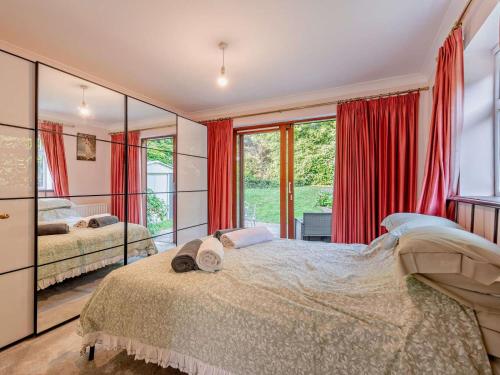 a bedroom with two beds and a large window at 1 Bed in Lymington oc-92403 in Ripley