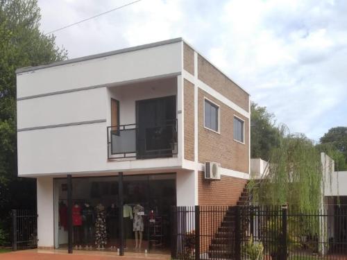 a building with a store front with a balcony at Hospedaje La Casa del Sauce in Obligado