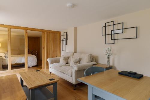 a living room with a couch and a table at Dunsa Cottage Bakewell Peak District in Bakewell