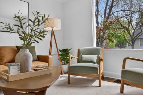 a living room with a coffee table and chairs at 10th St Retreat in Boise