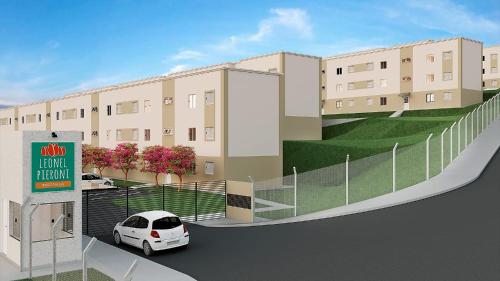 a white car parked in front of a building at Apartamento in Espirito Santo Do Pinhal