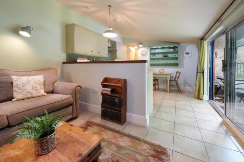 a living room with a couch and a table at The Old Wash House Chatsworth Estate in Baslow