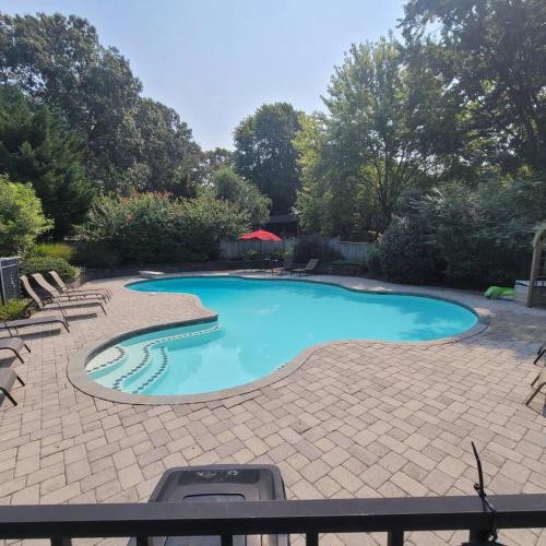 a swimming pool in a yard with a patio at Large Home with Private Pool, Gym, Sauna, 7 Bedrooms, Sleeps 21 in Severn
