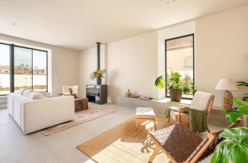 a living room with a couch and a table at Villa Flora in Colares