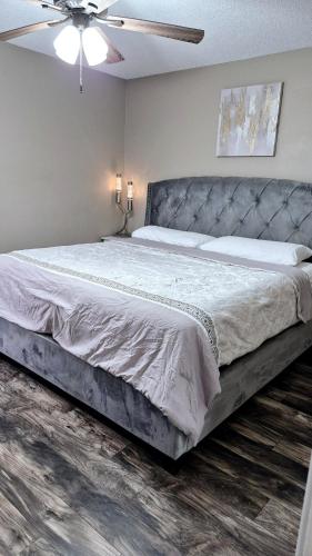 a bedroom with a large bed with a ceiling fan at A Beautiful Sunset in Clarksville