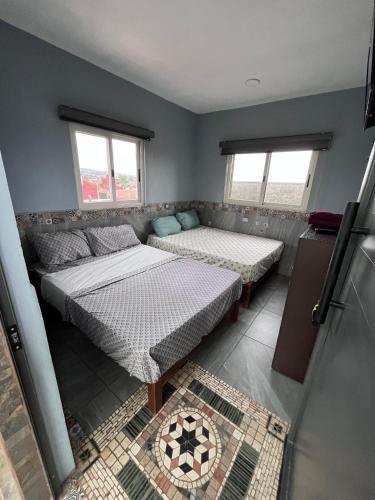 a room with two beds and a couch at Casa tequila club jacuzzi 4 in Arandas