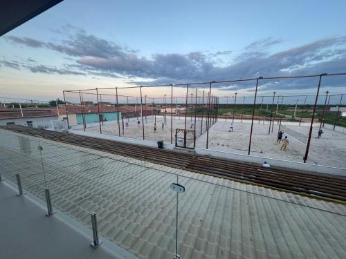 an empty volley ball court with people on the beach at Pousada Complexo Vibe in Baraúna