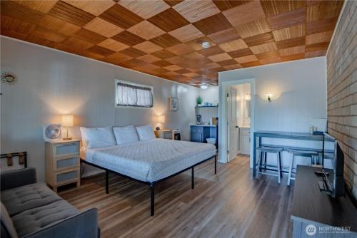 a bedroom with a bed and a desk in it at Fjordline Lodge in Hoodsport