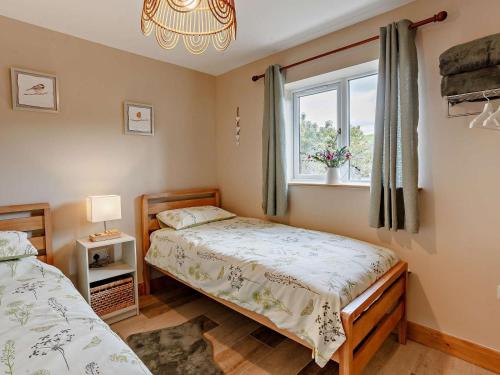a bedroom with two beds and a window at 2 Bed in Wells oc-90425 in Croscombe