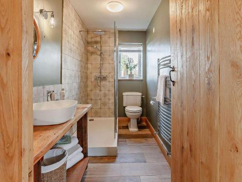a bathroom with a white sink and a toilet at 2 Bed in Wells oc-90425 in Croscombe