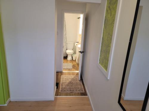 a hallway leading to a bathroom with a toilet at Warm cozy 1 bdrm close to Hwy in Edmundston