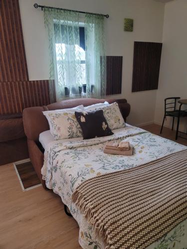a large bed in a room with a couch at Warm cozy 1 bdrm close to Hwy in Edmundston