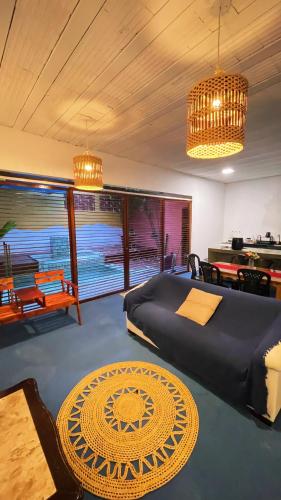 a bedroom with a bed and a table and chairs at Casa Mandala Canoa Quebrada in Aracati