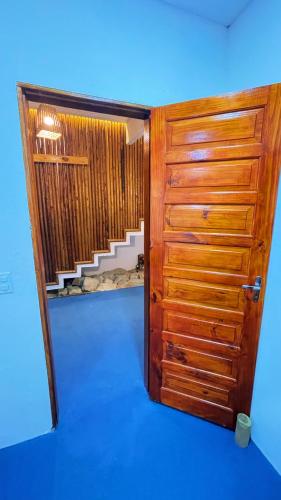 a room with a wooden door and a staircase at Casa Mandala Canoa Quebrada in Aracati