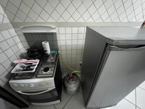 a small kitchen with a stove and a sink at Ap FIG Garanhuns in Garanhuns
