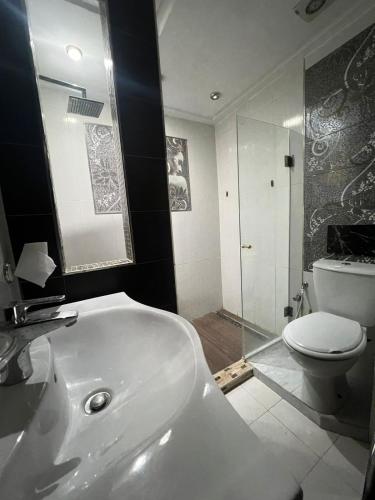 a bathroom with a white tub and a toilet at Residance Panorama 52 in Sousse