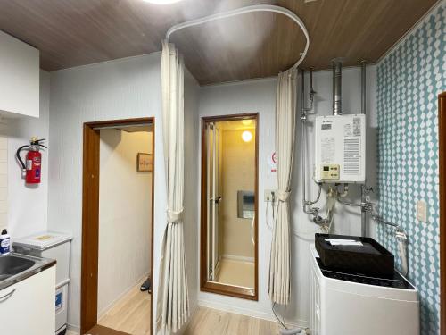 a bathroom with a sink and a shower in it at サイプレス平岸 in Sapporo