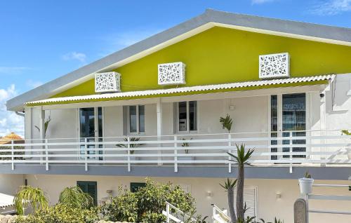 a white and green house with a balcony at Villa Sara in Ragusa