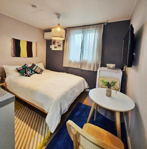 a small room with a bed and a table at The YoGwan in Suwon