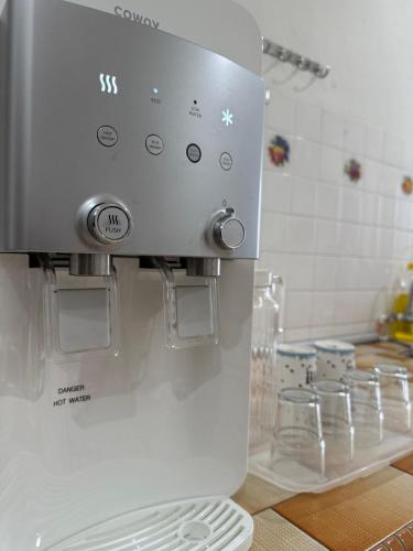a kitchen counter with a coffee machine on the wall at Ipoh Garden 4BR 10Pax in Ipoh