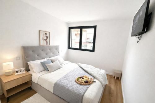 a bedroom with a bed with a bowl of food on it at CC Room Gaia in Vila Nova de Gaia