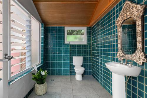 a bathroom with a toilet and a sink at Dolphins Backpackers in Sunshine Beach