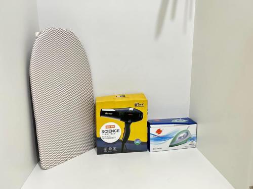 a picture of a box and a hair dryer at Sweden's Tiny Home, Studio Unit Condo in Manila