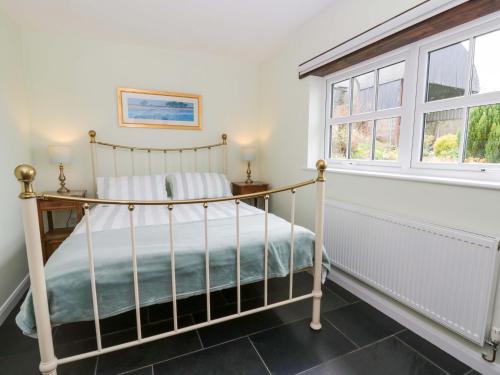 a bedroom with a bed and a window at Blaenffynnon Bach in Carmarthen