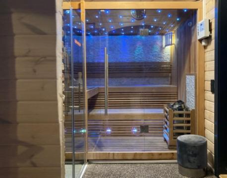 a room with a glass door with a window with lights at Blockhaus Kik im Harz in Sankt Andreasberg