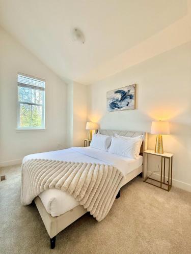 a white bedroom with a large bed and a window at Luxury 3Br Oasis Gated Yard Pets Welcome in Langley