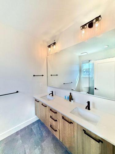 a bathroom with two sinks and a mirror at Luxury 3Br Oasis Gated Yard Pets Welcome in Langley