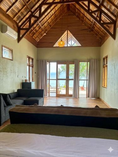 a living room with a large bed and a couch at The Sunrise Point in Katiet