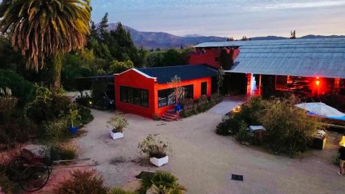 an overhead view of a red building with a yard at Strip Center Suites by Casona Lo Aguirre in El Monte