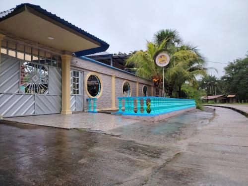 a blue bench in front of a building at Hotel Alto Amazonas in Leticia