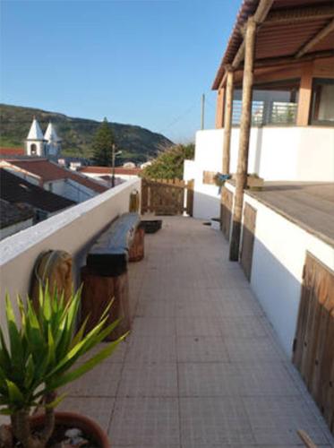 a walkway on a building with a plant on it at Casa do Porto da Horta in Horta