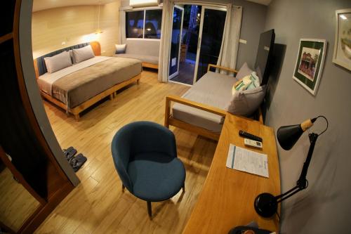 a bedroom with a bed and a desk and a chair at Silver Reef Dive Resort in Dauin