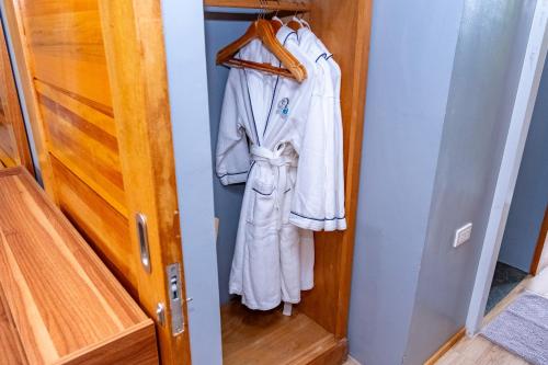 a closet with a robe hanging on a door at Silver Reef Dive Resort in Dauin