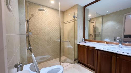 a bathroom with a shower and a toilet and a sink at The LH Homestay in Phú Quốc