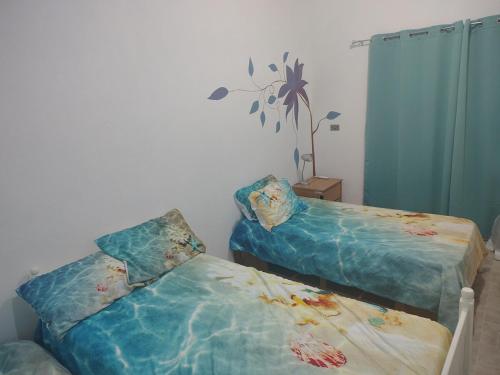 two beds sitting next to each other in a room at Arcadia 1 in Santiago