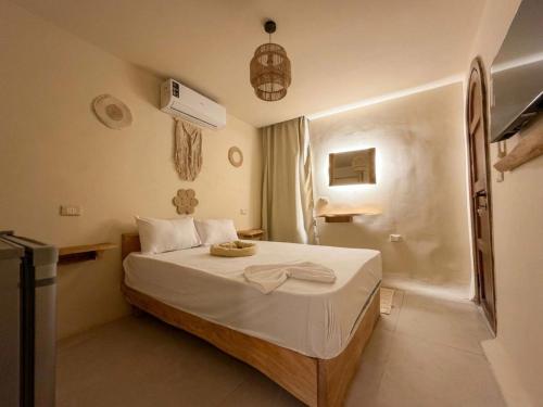 a bedroom with a bed with a bowl on it at nirvana pyramids view in Cairo