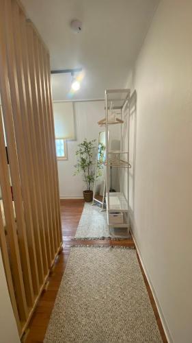 a hallway with a book shelf in a room at YuYu stay in Seoul