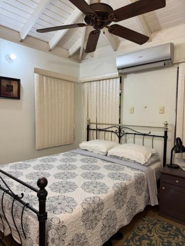 a bedroom with a bed with a ceiling fan at Driftwood 85 in Canaan