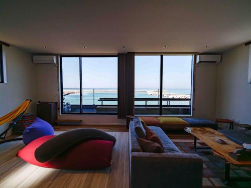 a living room with a view of the ocean at Private Ocean Resort YUUNAGI in Awaji